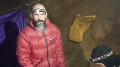 In this screen grab from video, American caver Mark Dickey, 40, talks to camera next to a colleague inside the Morca cave near Anamur, southern Turkey. AP