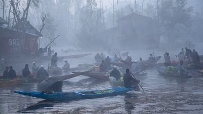 Kashmiri men sell their produce at the floating vegetable market on the Dal Lake surrounded by dense fog on a cold morning in Srinagar. Dar Yasin / AP Photo