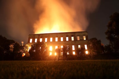 People watch as a fire burns at the National Museum of Brazil in Rio de Janeiro, Brazil September 2, 2018. Reuters