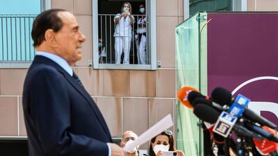 Medical staff take photos of former Italian prime minister Silvio Berlusconi as he addresses the media before leaving the San Raffaele Hospital in Milan. AFP