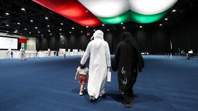 A family arrives early to vote on Tuesday. Election officials hope the flexibility of having three 'early voting' days this week and the main polling day on Saturday will boost voter turnout this year