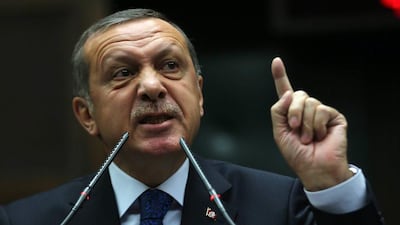 Turkey's President Recep Tayyip Erdogan talks to Justice and Development (AKP) party's members of parliament during a meeting at the Turkish parliament in Ankara. Adem Altan / AFP