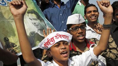 Fans of Indian cricket player Sachin Tendulkar shout support outside Wankhede Stadium on his retirement day in Mumbai on Saturday. Rajanish Kakade / AP Photo