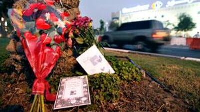 Floral tributes left on the central reservation on Airport Road outside Carrefour, where three sisters were killed on Monday.