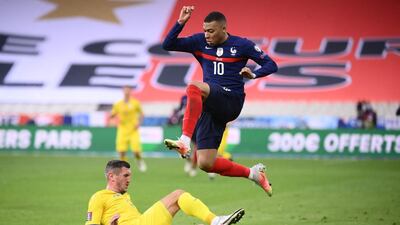 France's Kylian Mbappe jumps to avoid a tackle during the 1-1 draw with Ukraine. AFP