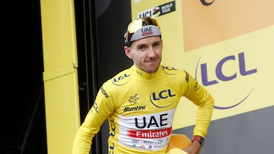 UAE Team Emirates rider Adam Yates on the podium after retaining the yellow jersey. Reuters