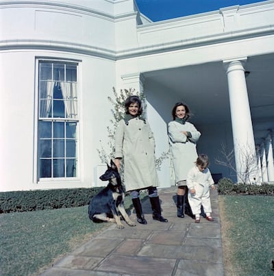 FILE PHOTO -- First Lady Jacqueline Kennedy (L) stands with her sister, Princess Lee Radziwill of Poland, and niece, Anna Christina Radziwill, on the walkway outside the Oval Office with the Kennedy family dog Clipper at the White House in Washington, D.C., January 15, 1963. Courtesy Cecil Stoughton/JFK Library/Handout via REUTERS ATTENTION EDITORS - THIS IMAGE WAS PROVIDED BY A THIRD PARTY.