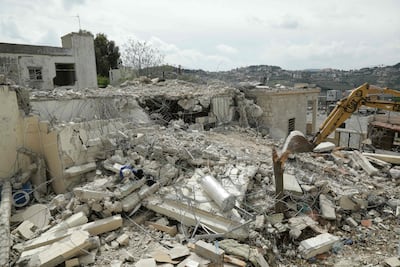 A bulldozer removes rubble from the site of an Israeli strike on a house in southern Lebanon on April 8. AFP