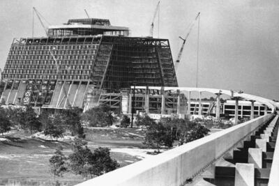Monorail tracks and concrete pilings lead to a hotel under construction at Walt Disney World in July 1971. AP