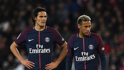 Paris Saint-Germain's Uruguayan forward Edinson Cavani (L) and Paris Saint-Germain's Brazilian forward Neymar react during the French Ligue 1 football match between Paris Saint-Germain (PSG) and Lyon (OL) at the Parc des Princes stadium in Paris. / AFP PHOTO / FRANCK FIFE