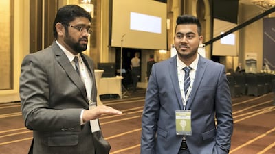 First place winners, Mohammed Rasly, left, and Osama Khan, at the British Computer Society National Students’ Innovation Award in Abu Dhabi where they presented their project "Smart Garbage Monitoring System". Reem Mohammed / The National