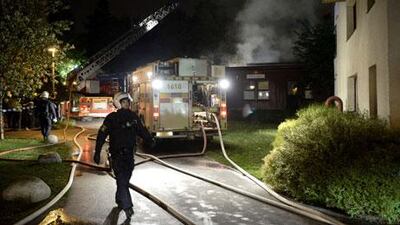 Swedish fire crews and police secure an area where a fire was started by rioters in a Stockholm suburb.