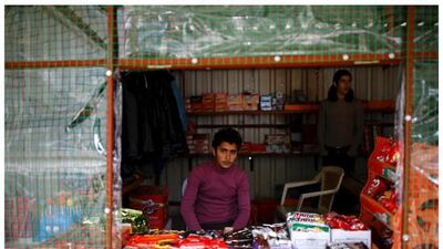 Syrian refugee Resad Bekur, 18, as he poses in a shop where he works in Yayladagi refugee camp in Hatay province, near the Turkish-Syrian border, Turkey,