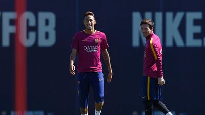 Barcelona’s Argentinian forward Lionel Messi (R) and Barcelona’s Brazilian forward Neymar (L) take part in a training session at the FC Barcelona Joan Gamper Sports Centre in Sant Joan Despi, near Barcelona on April 16, 2015, on the eve of the Spanish League match FC Barcelona v Valencia CF. AFP / LLUIS GENE