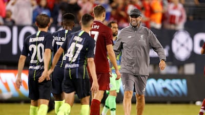 Liverpool manager Juergen Klopp celebrates with Nathaniel Phillips after the match. Reuters