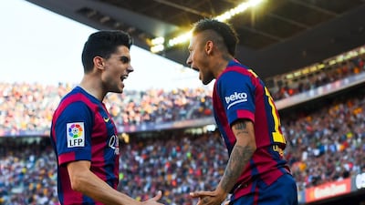 Neymar of Barcelona celebrates with teammate Marc Bartra after scoring against Real Sociedad in La Liga on Saturday. David Ramos / Getty Images