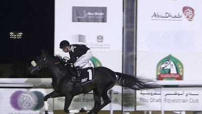 Tadhg O' Shea and AF Maqayes cross the finish line to win at the Abu Dhabi Equestrian Club. Jeffrey E Biteng / The National
