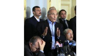 Egyptian Prime Minister Ahmed Shafiq talks during a press conference in Cairo, Egypt, Sunday, Feb.13, 2011. Egypt's military leaders dissolved parliament and suspended the constitution Sunday, meeting two key demands of protesters who have been keeping up pressure for immediate steps to transition to democratic, civilian rule after forcing Hosni Mubarak out of power. Seated at right, finance minister Samir Radwan, at left, interior minister, Mahmoud Wagdy. (AP Photo/Amr Nabil)