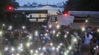 Demonstrators use the light of their cellphones as they gather during a protest against the death in Minneapolis police custody of George Floyd, near the White House in Washington, US. Reuters