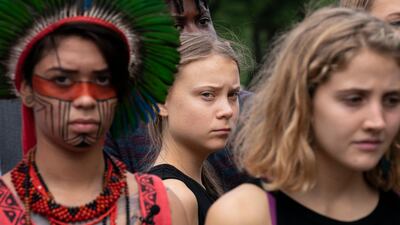 Swedish activist Greta Thunberg, center, who has called on world leaders to step up their efforts against global warming, stands with indigenous people of the Americas and others. AP