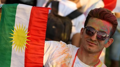 An Iraqi Kurd holds a Kurdish flag during an event to urge people to vote in the upcoming independence referendum in Erbil. Sarin Hamed / AFP Photo