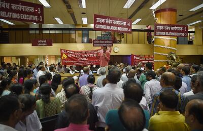 Indian Punjab National Bank workers stage a protest inside a branch in Mumbai on May 30, 2018. Nearly one million Indian public sector and regional rural bank employees are staging a two-day nationwide strike, demanding wage revisions. Photo: AFP