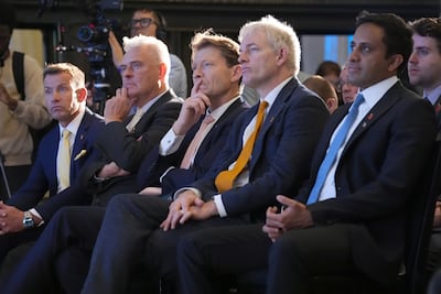 (Left to right) Reform UK chairman David Bull, MP for Ashfield Lee Anderson, deputy leader Richard Tice, Danny Kruger and Head of Policy Zia Yusuf, listen as leader Nigel Farage delivers his speech at Banking Hall in the City of London. PA
