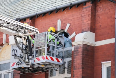 A firefighter inspects the damage inflicted on Southport mosque. PA
