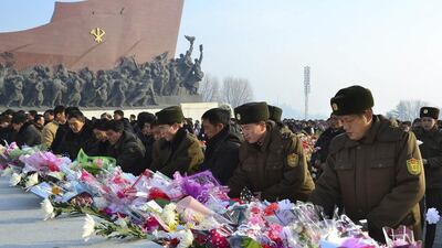 North Koreans offer flowers in front of statues of North Korea's founder Kim Il Sung and former leader Kim Jong Il at Mansudae hill in Pyongyang, on the second anniversary of the death of Kim Jong Il. KCNA via Reuters