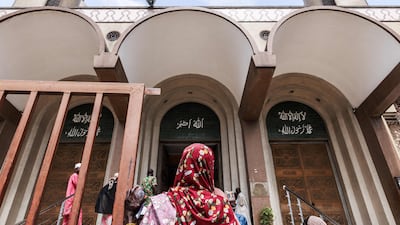 A woman stands in front of the Lagos Central Mosque in Lagos. AFP