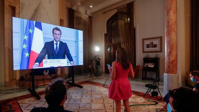 French President Emmanuel Macron listens to a Lebanese journalist's questions during a virtual press conference broadcast at the Pine Residence, the official residence of the French ambassador, in Beirut. AFP