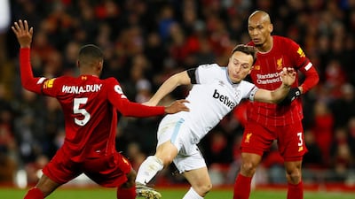West Ham United's Mark Noble in action with Liverpool's Georginio Wijnaldum and Fabinho. Reuters