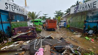 Debris from damaged buildings is strewn across a road in Carita. AFP