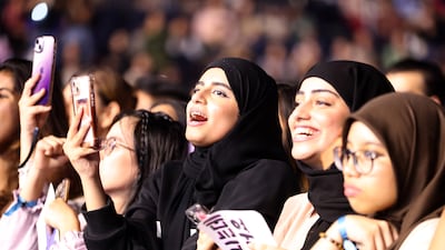 K-pop fans in the crowd at Coca-Cola Arena
