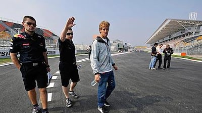 Sebastian Vettel and members of the Red Bull-Renault team walk around the Korean track in Yeongnam yesterday as the German driver tries to familiarise himself with the new circuit ahead of today’s opening practice sessions.
