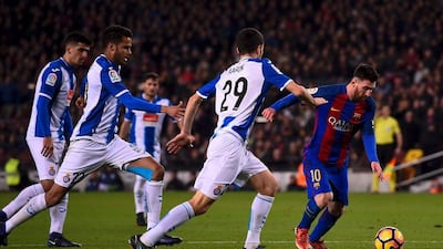 Lionel Messi slaloms past the Espanyol defence. Josep Lago / AFP