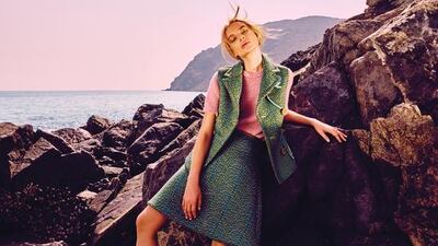 SUIT OF THE SEASON: Sweater, Vest and skirt, price on request, Prada; Brooch, Dh2,815, Prada; Shoes, Dh2,175, Prada; Rings, from Dh400, Monica Vinader at Boutique 1