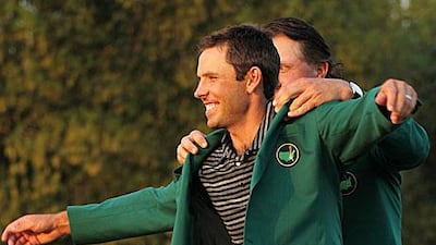 Phil Mickelson presents Charl Schwartzel with the winner's green jacket in Augusta, Georgia. Jamie Squire / Getty Images