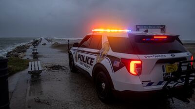 A police car blocks the entrance to the Inlet State Park before the expected arrival of Hurricane Nicole in Fort Pierce, Florida. Reuters