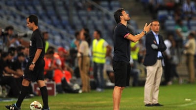 Barcelona manager Luis Enrique reacts during his side's 1-0 friendly victory over Recreativo de Huelva on Saturday. The match earned Barca the Colombino Trophy, which Huelva host a tournament to award every year commemorating their status as Spain's oldest club. Cristina Quicler / AFP / July 19, 2014