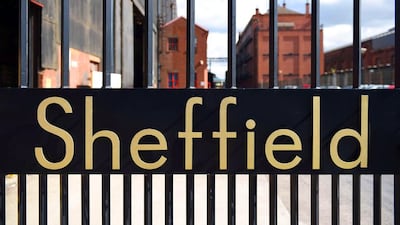 The word “Sheffield” sits in the entrance gates to a Sheffield steel mill. Oli Scarff / AFP