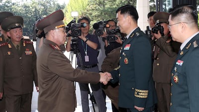 North Korean Lt Gen An Ik San, centre left, shakes hands with South Korean Maj Gen Kim Do-gyun upon his arrival at the Peace House at the border village of Panmunjom in 2018