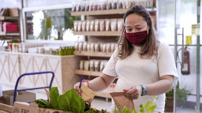 A store worker arranges online orders for delivery.
