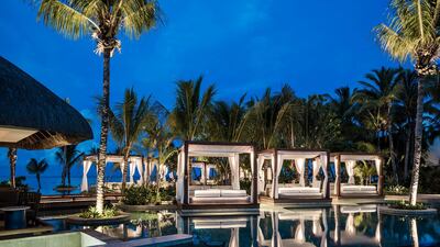 The resort pool in the evening. One&Only Le Saint Geran