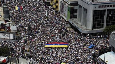 Opposition activists backing Venezuelan opposition leader Juan Guaido pour onto the streets. Federico Parra / AFP