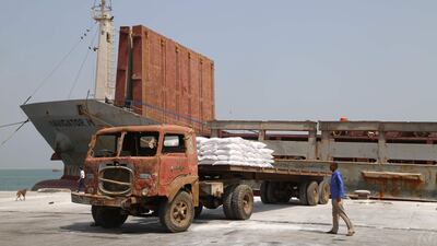 A Yemeni man walks past a food aid shipment from the World Food Programme in the port city of Hodeidah. AFP