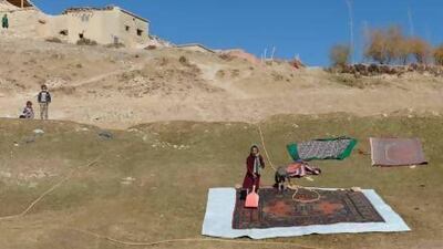 Hazara children wash a carpet on a hillside in Band-e Amir, Bamiyan province, about 200 kilometres north-west of Kabul, Afghanistan. Anna Badkhen's latest book, The World is a Carpet: Four Seasons in an Afghan Village, based on the year she spent in a remote Afghan village, has as one of its central themes the region's famous tradition of carpet-making, for which they rely upon heavily for survival. Massoud Hossaini / AFP