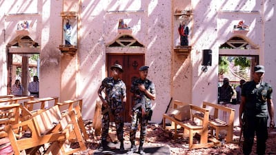 Sri Lankan soldiers look on inside the St Sebastian's Church at Katuwapitiya in Negombo on April 21, 2019, following a bomb blast during the Easter service. AFP / STR