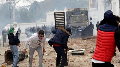 People clash with anti-riot police during the protest against President Abdelaziz Bouteflika, in Algiers, Algeria. Reuters