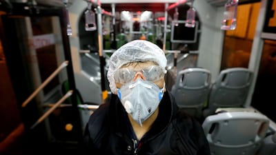A Tehran Municipality worker cleans a bus to avoid the spread of the illness in Iran. AFP